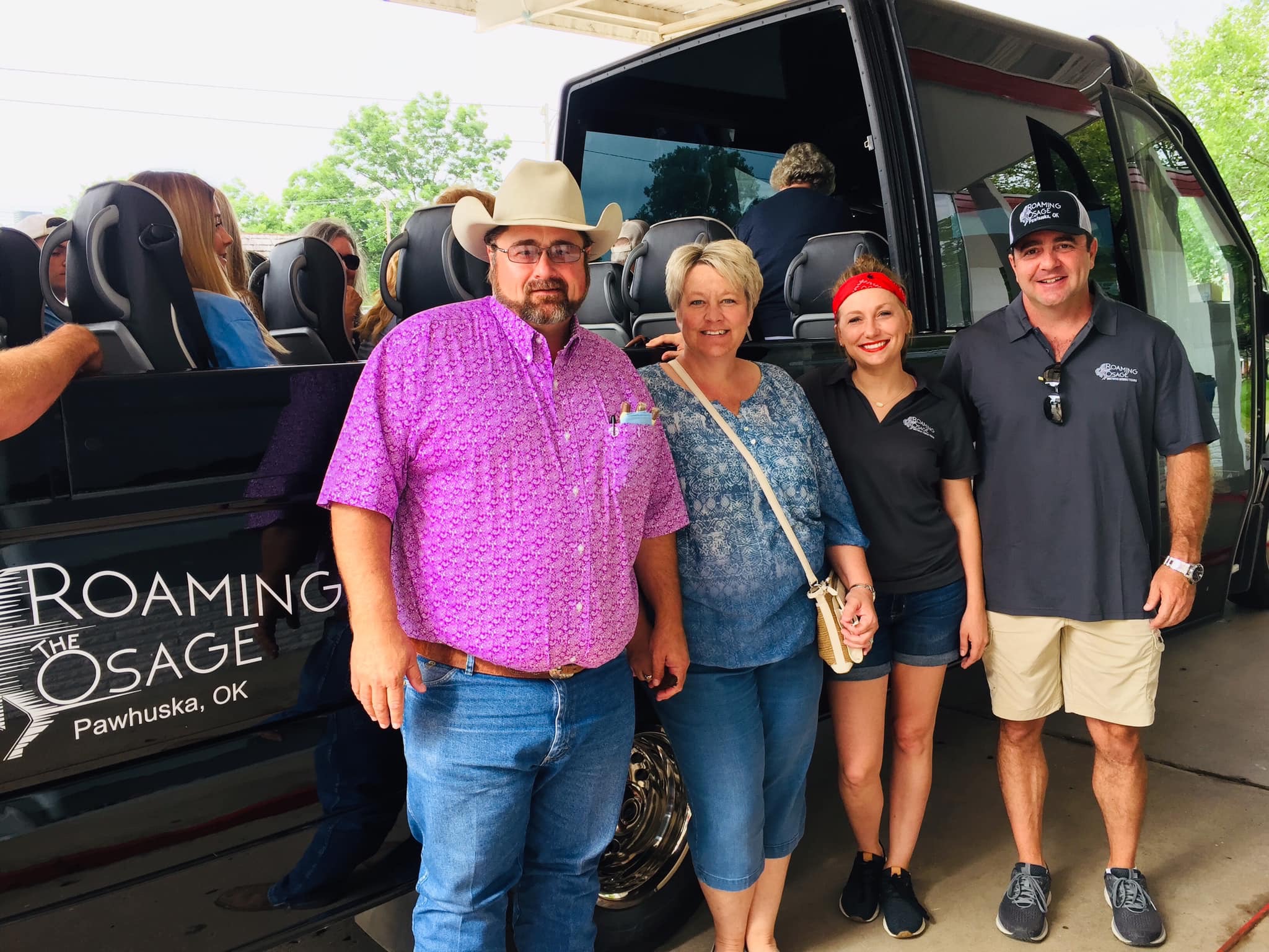 JImmy Don Holmes and wife with Amanda and Casey of Roaming the Osage standing in front of the Roaming the Osage van